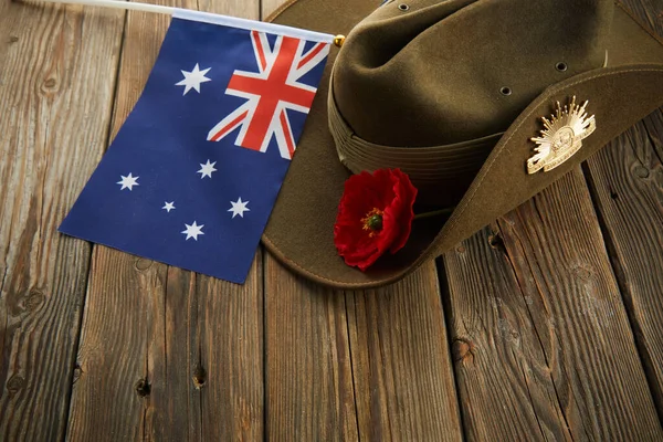 Anzac armé slouch hatt med australisk flagga och vallmo på trä bakgrund — Stockfoto