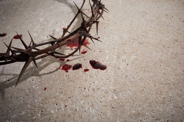 Conceito de Páscoa. Coroa de espinhos com unhas e gotas de sangue em um fundo de pedra. — Fotografia de Stock