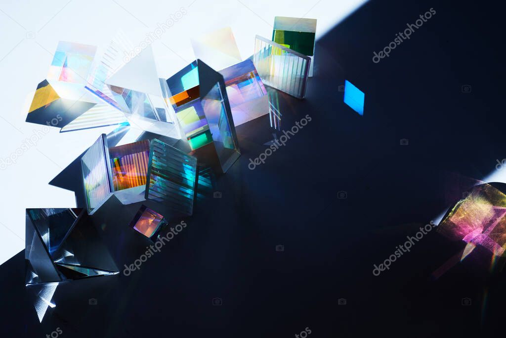 Geometric figures prisms with light diffraction of spectrum colors and reflection with trendy light.