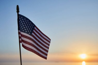 Flag of United States of America in mild sunset light