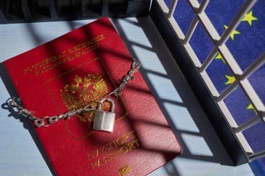 Russian passport chained in a chain with a padlock is located. Prohibition of Schengen visas for Russian tourists to travel to the European Union concept