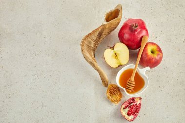 Rosh hashanah, jewish New Year holiday concept. Pomegranate, apples and honey traditional products for celebration.