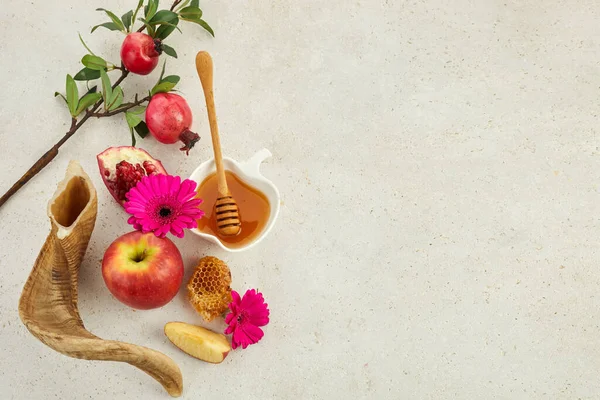 Rosh hashanah, jewish New Year holiday concept. Pomegranate, apples and honey traditional products for celebration.