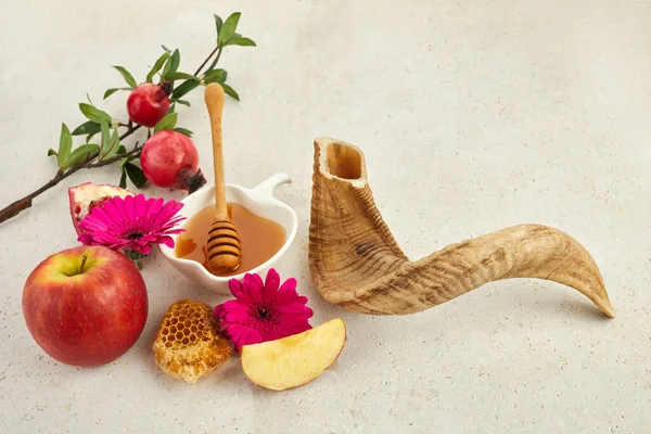 Rosh hashanah, jewish New Year holiday concept. Pomegranate, apples and honey traditional products for celebration.