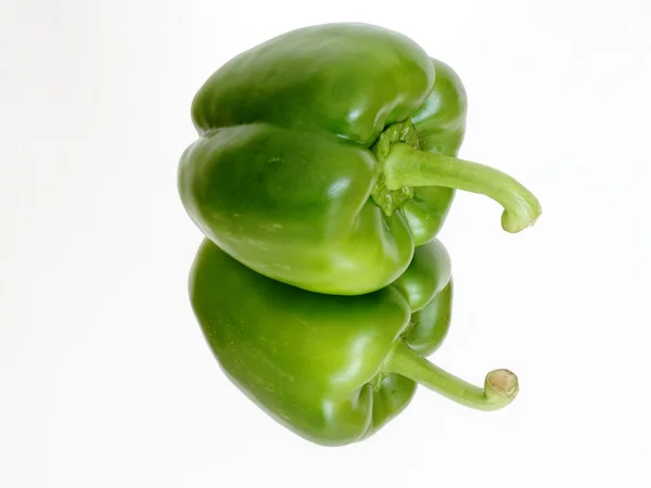 Green pepper on the mirror — Stock Photo, Image