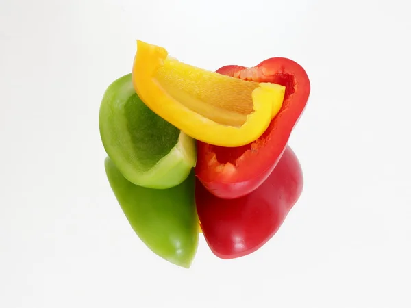 Three pieces of peppers on the mirror — Stock Photo, Image
