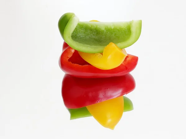 Three pieces of peppers on the mirror — Stock Photo, Image