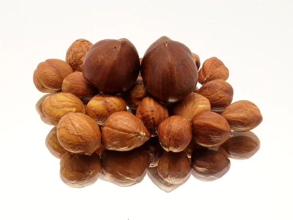 Pile of hazelnuts on mirror — Stock Photo, Image