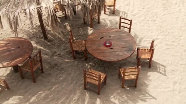 Table and chairs on the beach — Stock Video