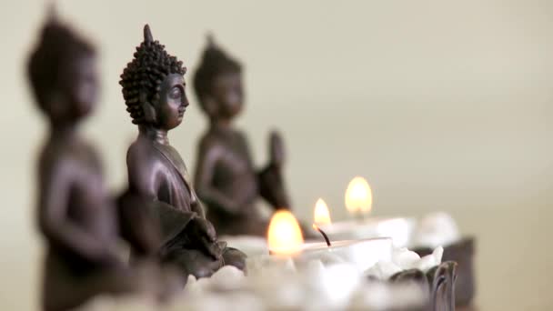 Buddah statuettes with candles — Stock Video