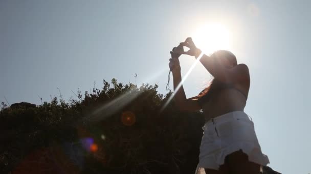 Kvinnan tar bild på stranden — Stockvideo