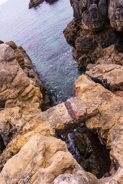 Rocks over blue ocean water — Stock Photo, Image