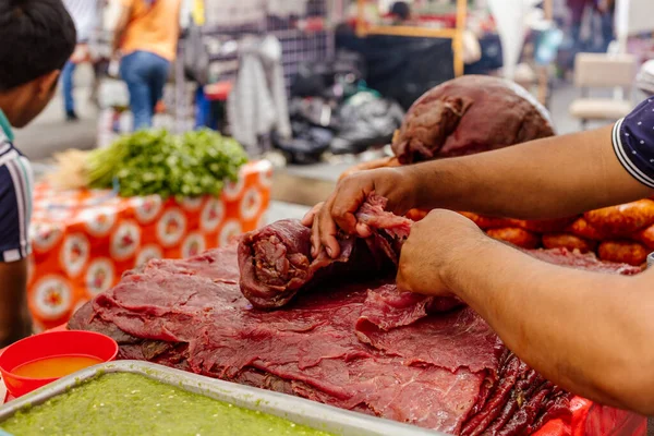 preparation of meat for roasting for sale in a market