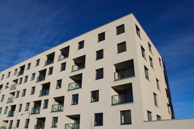 Prag, Çek Cumhuriyeti - 22 Ocak 2022: Prag 'ın yerleşim bölgelerinden birinde modern tarzda yeni bir apartman binası. Ön cephe beyaz ve balkonlar inşa edilmiş..