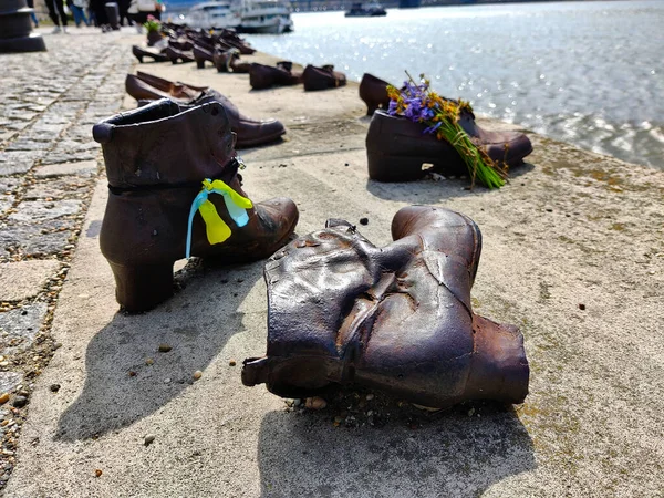 Budapeşte, Macaristan - 10 Nisan 2022: 2. Dünya Savaşı sırasında Yahudilerin katledilmesi anısına bronz ayakkabı heykeli.