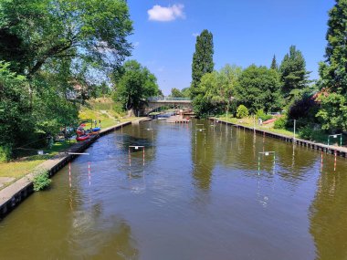 Güzel bir yaz gününde etrafı ağaçlarla çevrili su kanalları..