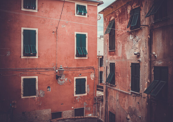 Old buildings and windows with shutters in small village in Italy. Toned picture