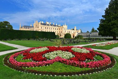 Lednice Chateau with beautiful gardens and parks on sunny summer day. Lednice-Valtice Landscape, South Moravian region. UNESCO World Heritage Site. Beautiful old romantic castle.