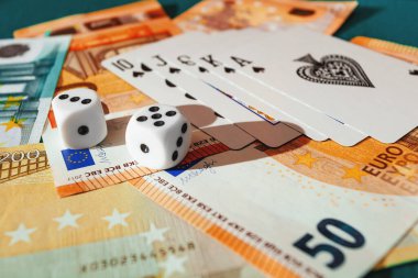 Chisinau, Moldova - 20. On iki. 2020 zar, kumarhane dolarları ve euro banknotlarıyla yeşil kumaş üzerinde kağıt oynamak. 