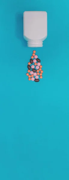 Multicolored Pills Falling Out Jar Panorama Blue Background — Stock Photo, Image