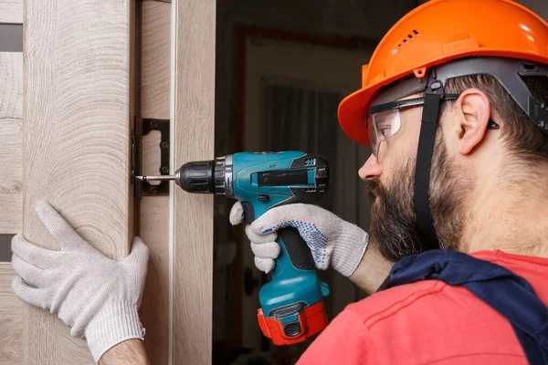 Worker Drill Orange Helmet Installs Door House — Stock Photo, Image