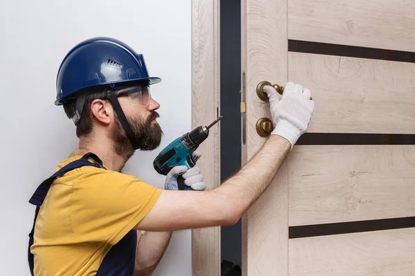 Travailleur Avec Une Perceuse Dans Casque Orange Installe Une Porte — Photo