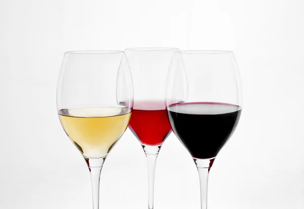 Tres copas de vino sobre fondo blanco Stock Photo