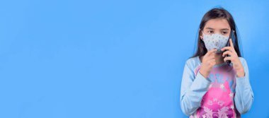 young woman with face mask holding a cup