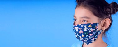 Siyah maskeli komik bir kız. Coronavirus mavisi. Komik bir ifade. Covid-19. Panorama arka planı. Kes şunu-19.