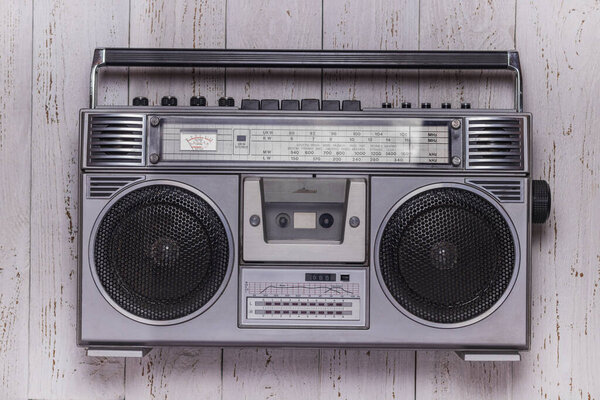 Cassette retro tape recorder on a white vintage wood background