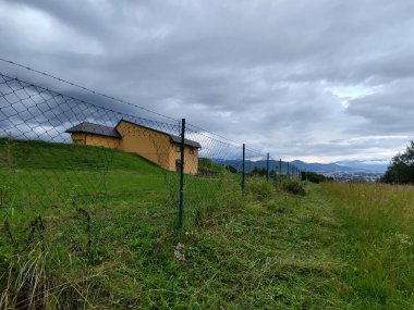 Yeşil çayırda inşaat ve demir çit