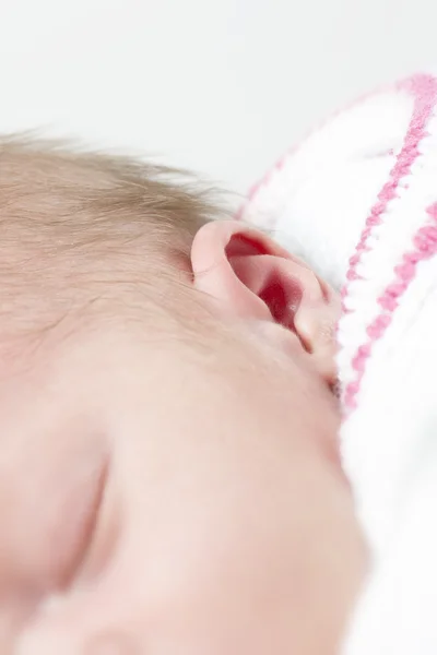 Baby face closeup white and pink clothing — Stock Photo, Image