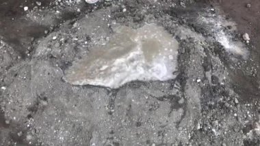 Construction workers mix cement and sand to make plaster dough for civil construction materials