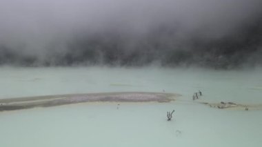 Beyaz krater, bant gübresi ve Endonezya 'da hava manzarası dumanlı havada uçar.