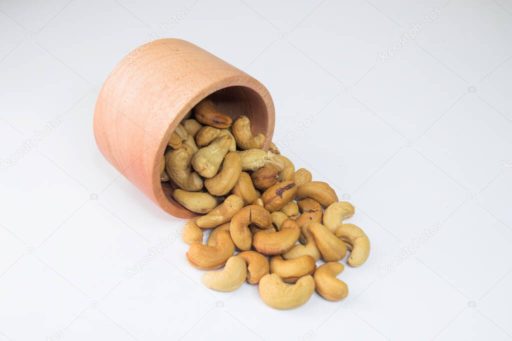 Cashew Nut, in Indonesia known as Kacang Mete. Served in a small bowl on white background.