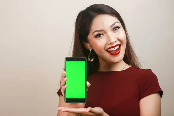 Happy Smiling Young Asian Woman Showing Pointing Green Blank Screen — стокове фото