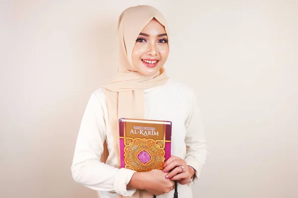 年轻的亚洲穆斯林妇女笑着拿着古兰经 — 图库照片