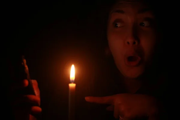 Asian Woman Shocking Pointing Cellphone Front Candle Light Dark Night — Stock Photo, Image