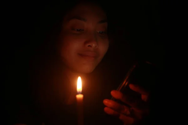 Asian Woman Smiling Her Cellphone Candle Dark Night — Photo