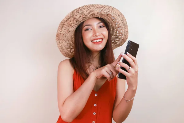 Excited Smiling Young Asian Woman Pointing Finger Smartphone Her Hand — стокове фото