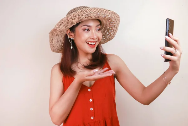 Excited Smiling Young Asian Woman Pointing Finger Smartphone Her Hand — стокове фото