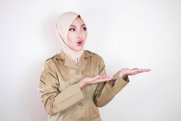 Young Asian Muslim Woman Wearing Brown Uniform Hijab Pointing Empty Stock Picture