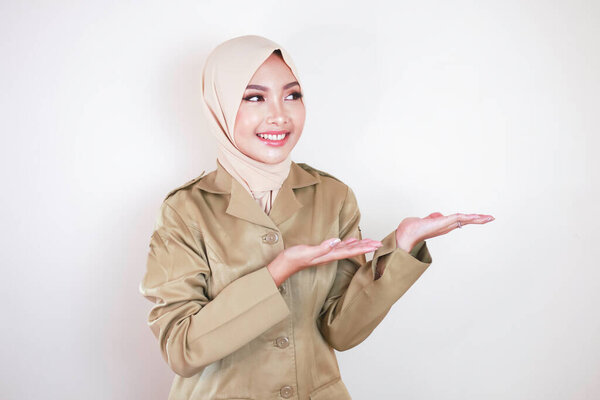 Young Asian Muslim Woman Wearing Brown Uniform Hijab Pointing Empty Stock Image