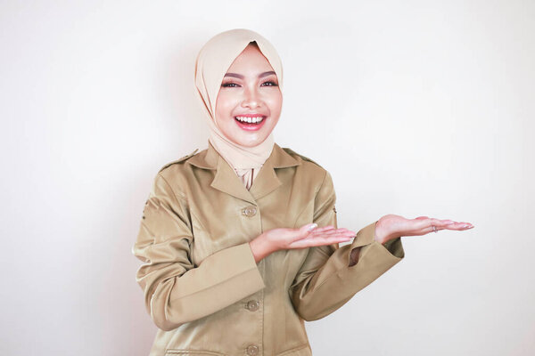 Young Asian Muslim Woman Wearing Brown Uniform Hijab Pointing Empty Royalty Free Stock Photos