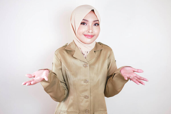 Young Beautiful Asian Muslim Worker Wearing Brown Uniform Hijab Presenting Stock Image