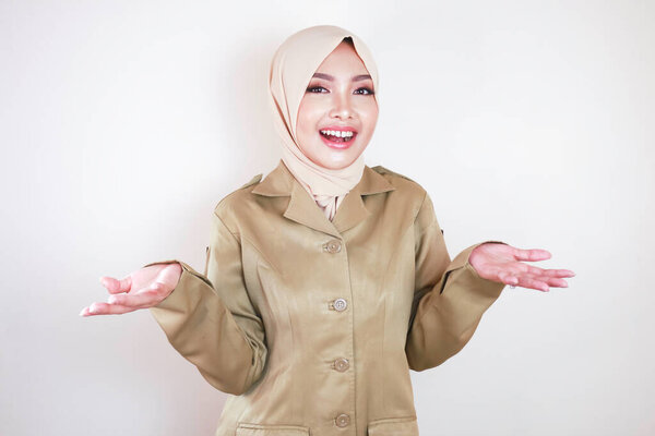 Young Beautiful Asian Muslim Worker Wearing Brown Uniform Hijab Presenting Royalty Free Stock Images