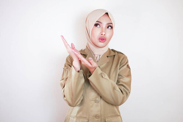 Young Asian Muslim Woman Wearing Brown Uniform Hijab Thinking Great Royalty Free Stock Photos