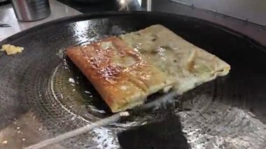 The process of making or cooking an Martabak Telur or Martabak Eggs, Indonesian street food. 