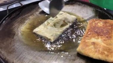 The process of making or cooking an Martabak Telur or Martabak Eggs, Indonesian street food. 