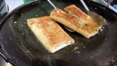 The process of making or cooking an Martabak Telur or Martabak Eggs, Indonesian street food. 